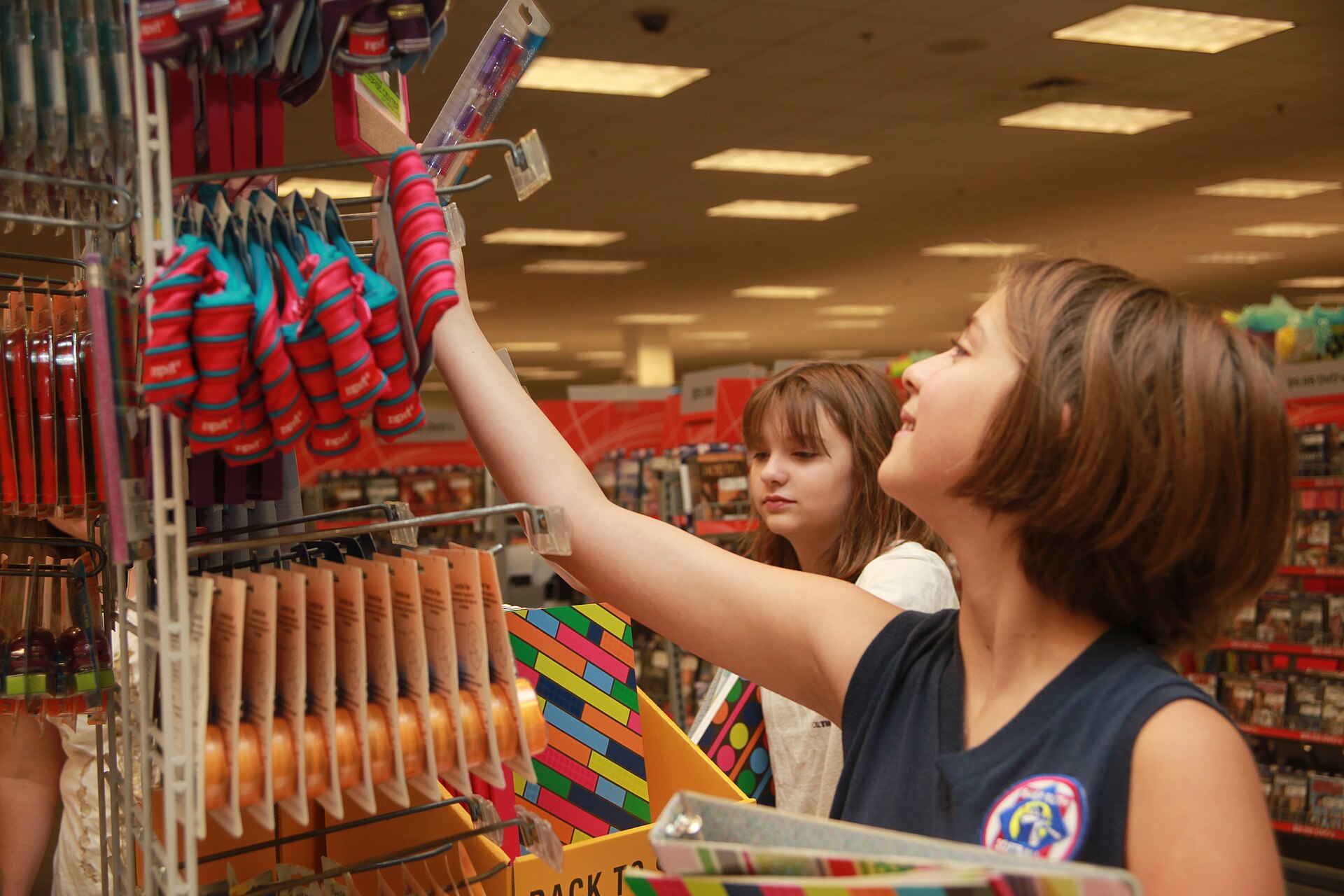 Isabel and Elizabeth Price, 11 and 12-years-old, shop for school supplies for the upcoming year at school supplies at the Marine Corps Ai…